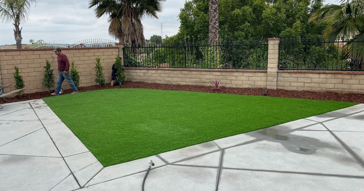 Bustos Landscaping’s social preview photograph of artificial turf within a scored concrete backyard patio